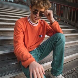 A orange long sleeve stussy shirt